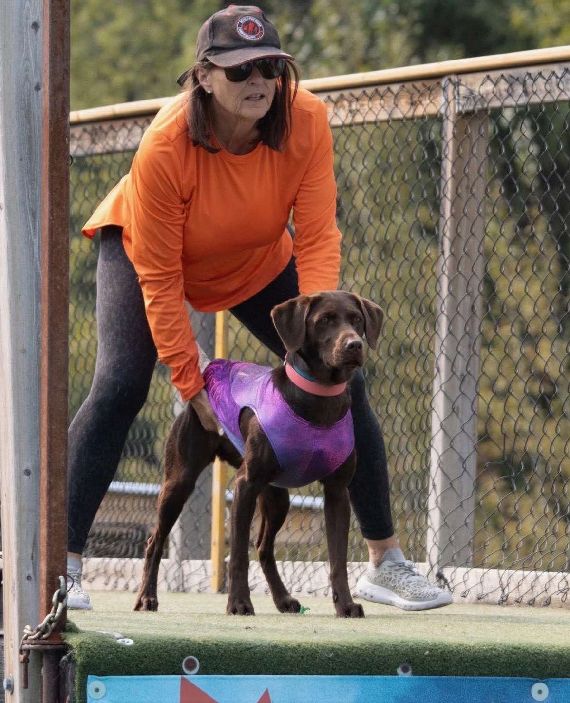 Meghan Lahti at a dock diving competition with her chocolate lab