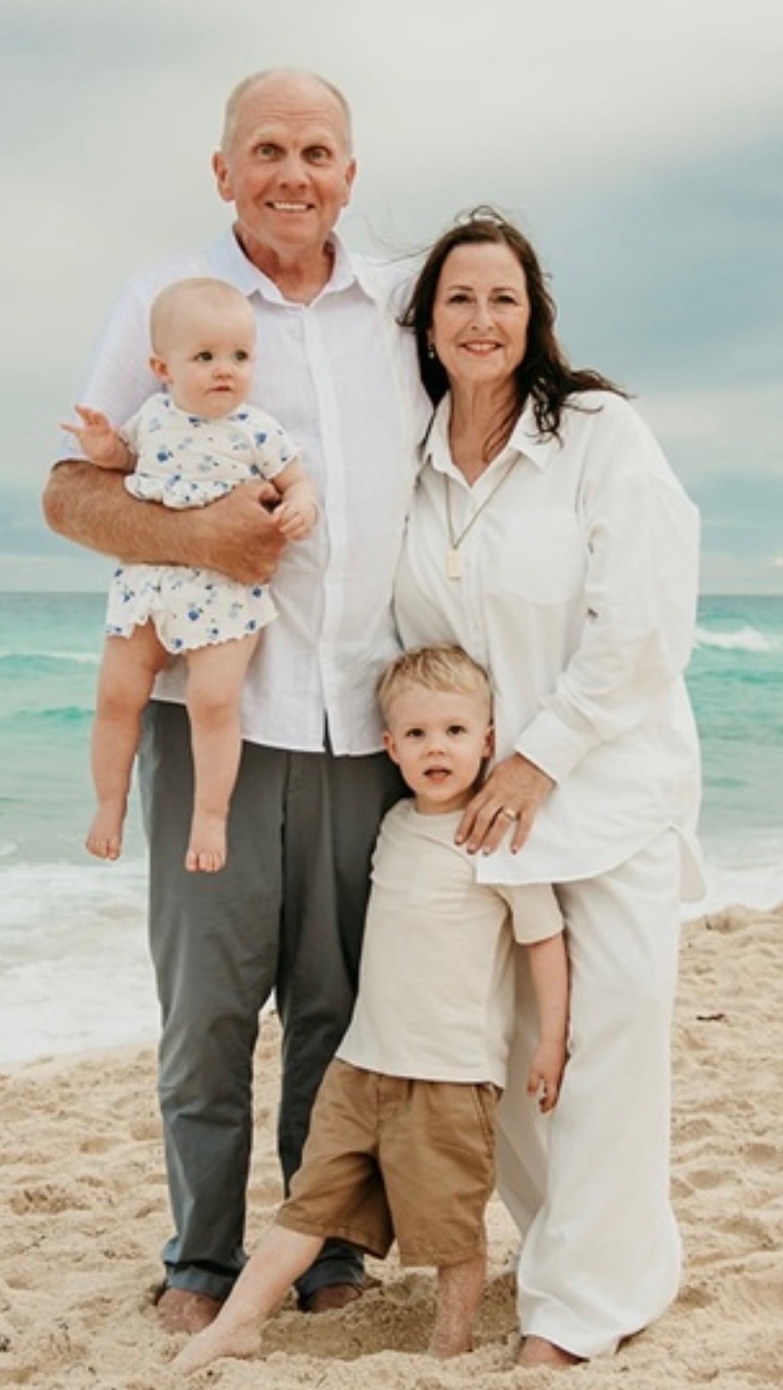 Meghan Lahti and her husband with two of their grandchildren at the beach