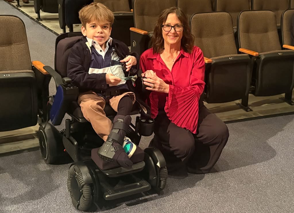 Spencer Moore receiving the 2025 Youth Sports Award from Meghan Lahti